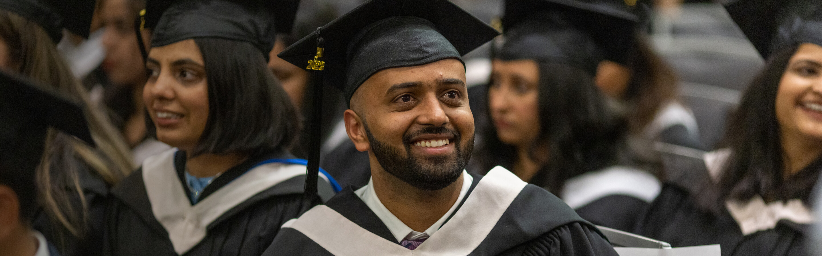 Male graduate wearing cap and gown